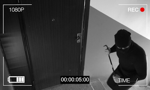 Burglar entering property with crowbar